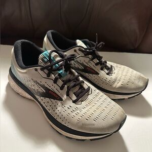 Brooks running shoes in light gray with black and teal accents